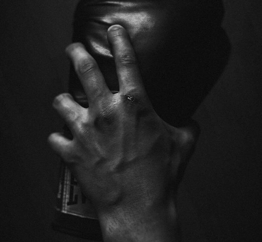 Grayscale Photo of Person Holding Boxing Glove